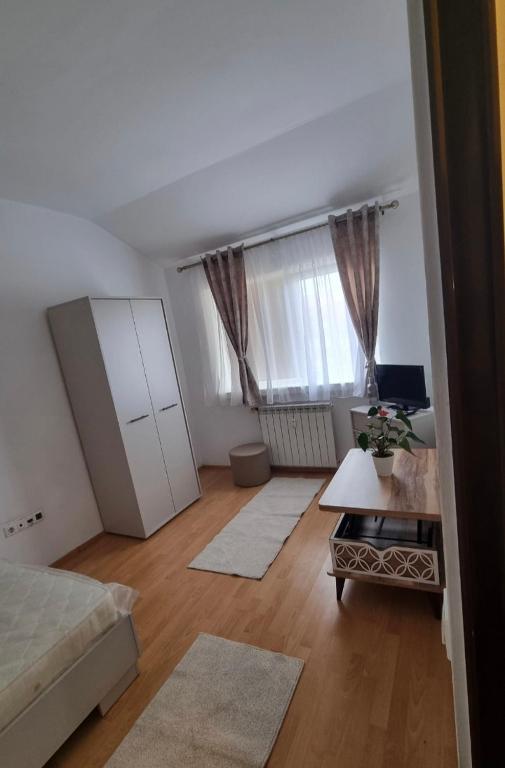 a living room with a bed and a table at Enjoy Eden in Constanţa