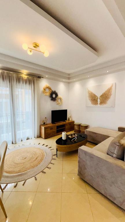 a large living room with a couch and a table at Fay's Apartment in Limenas