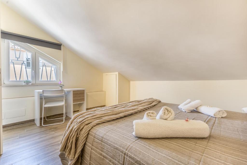 a bedroom with a bed with two towels on it at Fly&Rest Ciampino in Ciampino