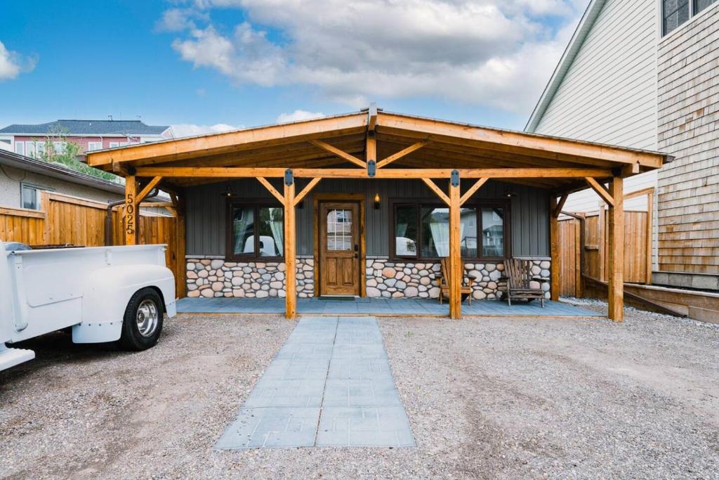 a house with a wooden building with a garage at Rustic Old West Cabin 1 Block to Beach Accessible Private Yard in Sylvan Lake