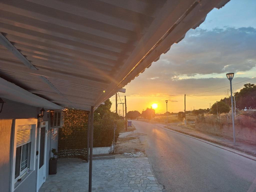 an empty street with the sunset in the background at Eva's house in Xanthi