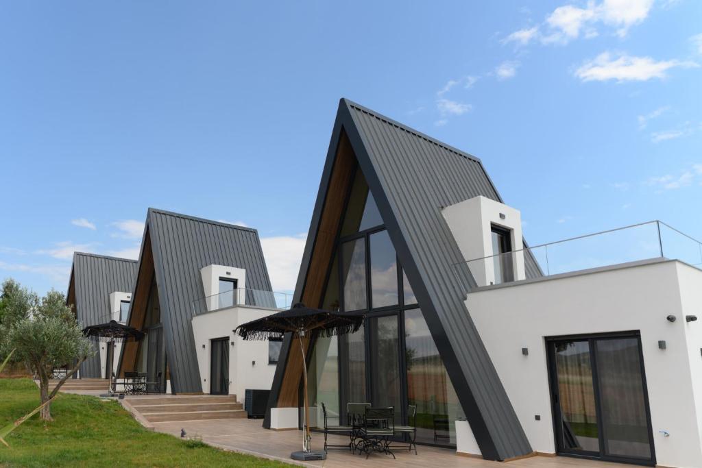 a house with a black roof at Trilogy Resorts in Alexandroupoli