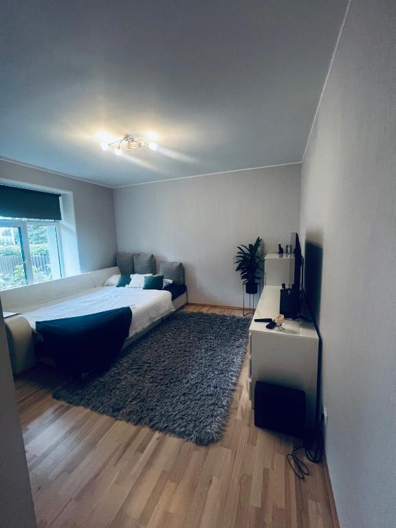a bedroom with a bed and a table and a television at 1 room apartment with its own yard in Pärnu