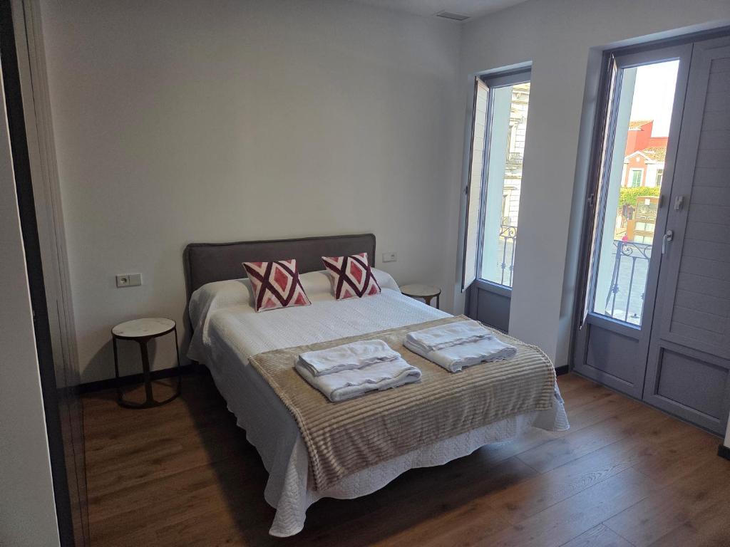 a bedroom with a bed with two pillows on it at Luxury Apartament Plaza in Alcazar de San Juan