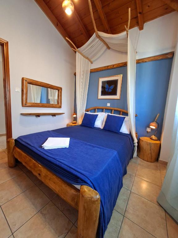 a bedroom with a blue bed with a blue comforter at Blu Casa Del Mare in Monemvasia