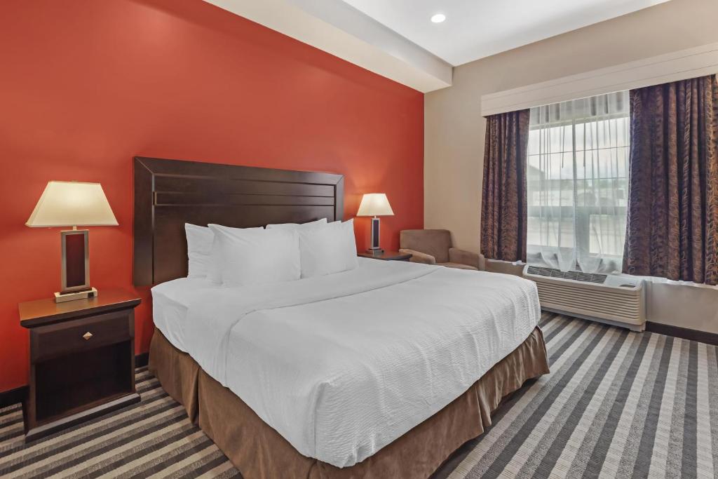 a hotel room with a large bed and a window at Best Western Plus Meridian in Lloydminster