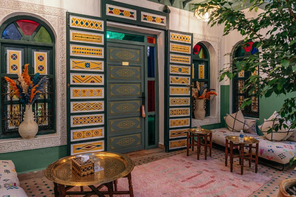 a room with a door with a table and chairs at The Little Hara in Marrakesh