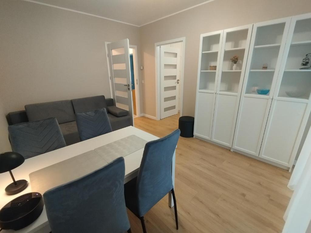 a living room with a couch and a table and chairs at Royal Apartment in Rumia