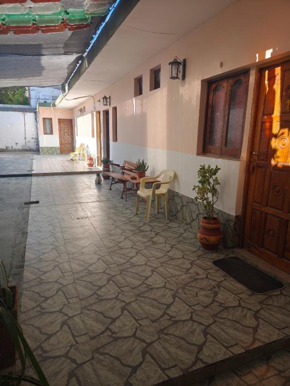 a hallway with benches and tables in a building at Hospedaje Dos Soles - Centro in Termas de Río Hondo