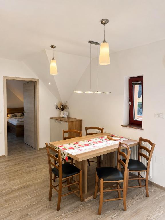 a kitchen and dining room with a table and chairs at Apartmaji Kramar Rateče in Kranjska Gora