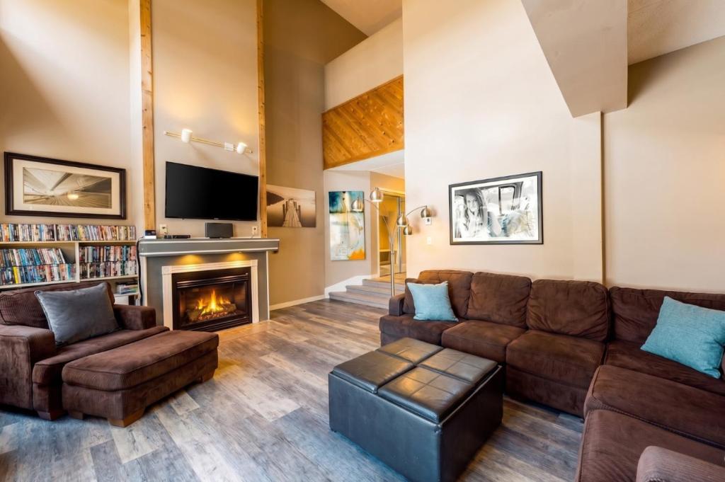 a living room with a couch and a fireplace at Wintergreen 116 in Blue Mountains