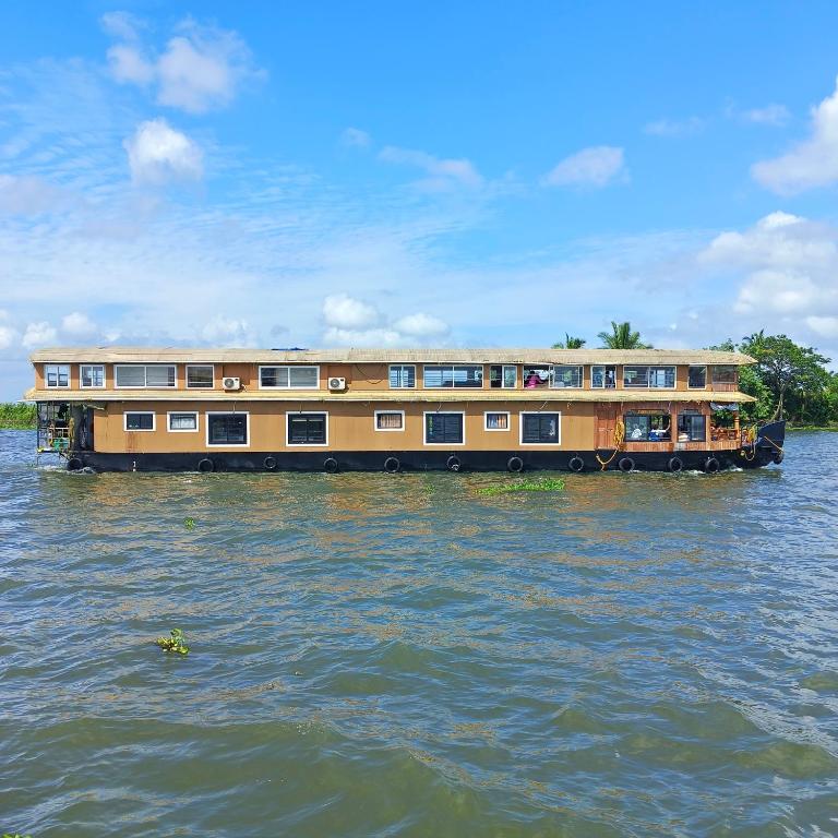 a house boat in the water on a river at Navora Houseboats in Alleppey