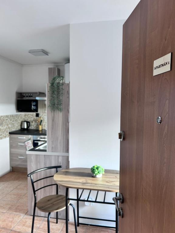 a kitchen with a wooden table and chairs and a table at Apartmán Líšný - U Jizery in Líšný