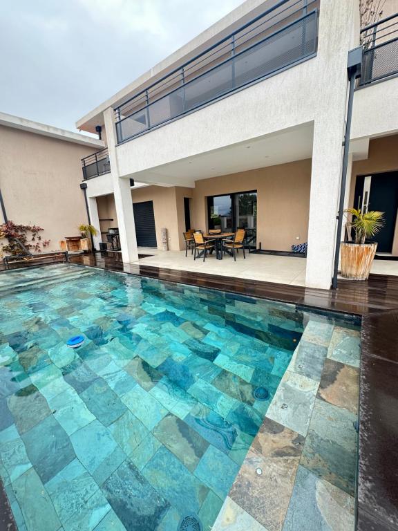 a swimming pool in front of a house at Dolce Vita in Fréjus