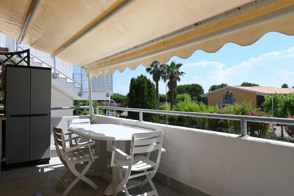 a white table and chairs on a balcony with a view at M473 - Marcelli, trilocale con posto auto e wifi in Marcelli