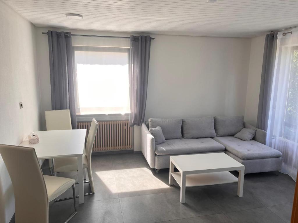 a living room with a couch and a table at Ferienwohnung Talglück in Weissach Im Tal
