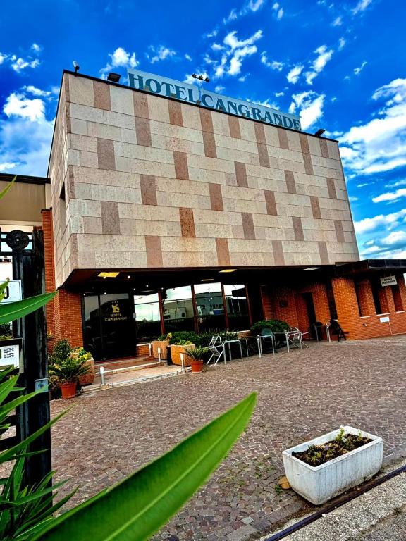 a building with a sign on the front of it at Hotel Cangrande Di Soave in Soave
