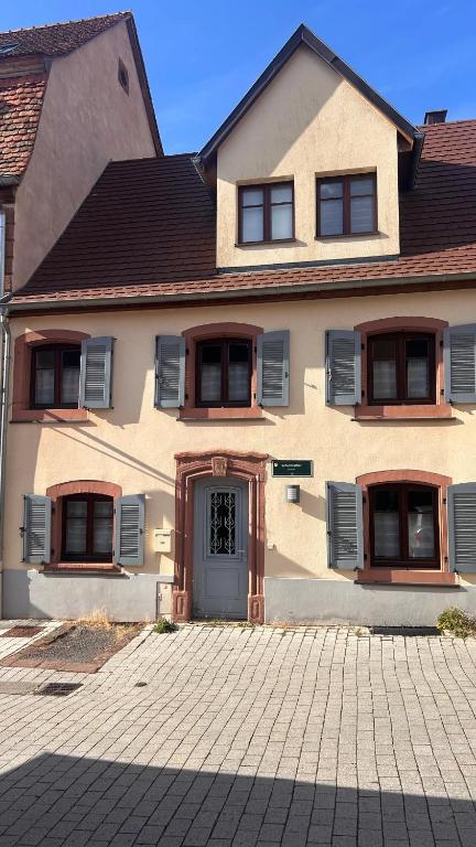 a large house with a door on a brick driveway at Le cordonnier du Staedel in La Petite-Pierre