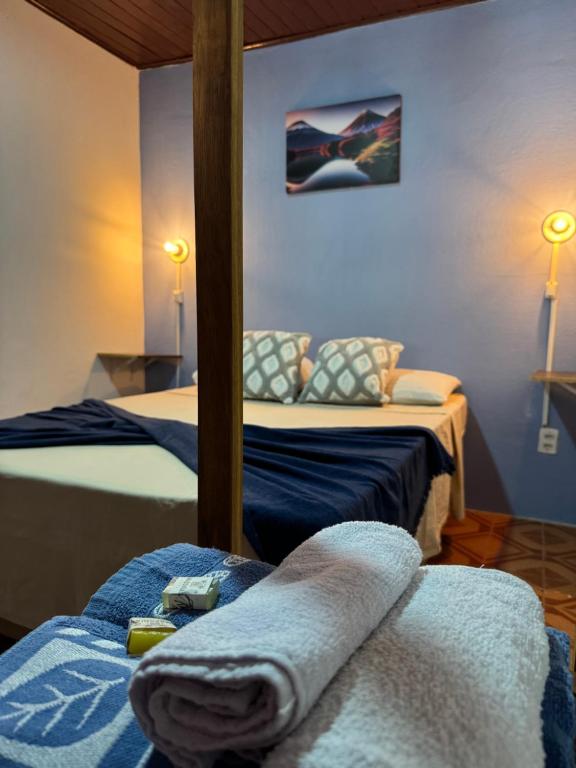 a hotel room with two beds and a towel at Hostel amazonia in Búzios