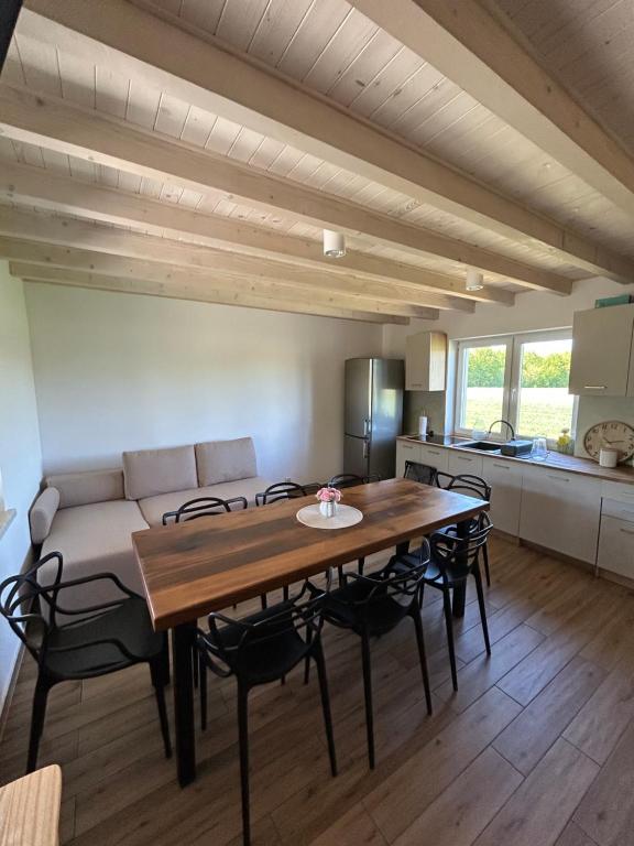 a living room with a table and a couch at Noclegi u Dąbka 2 in Głębokie