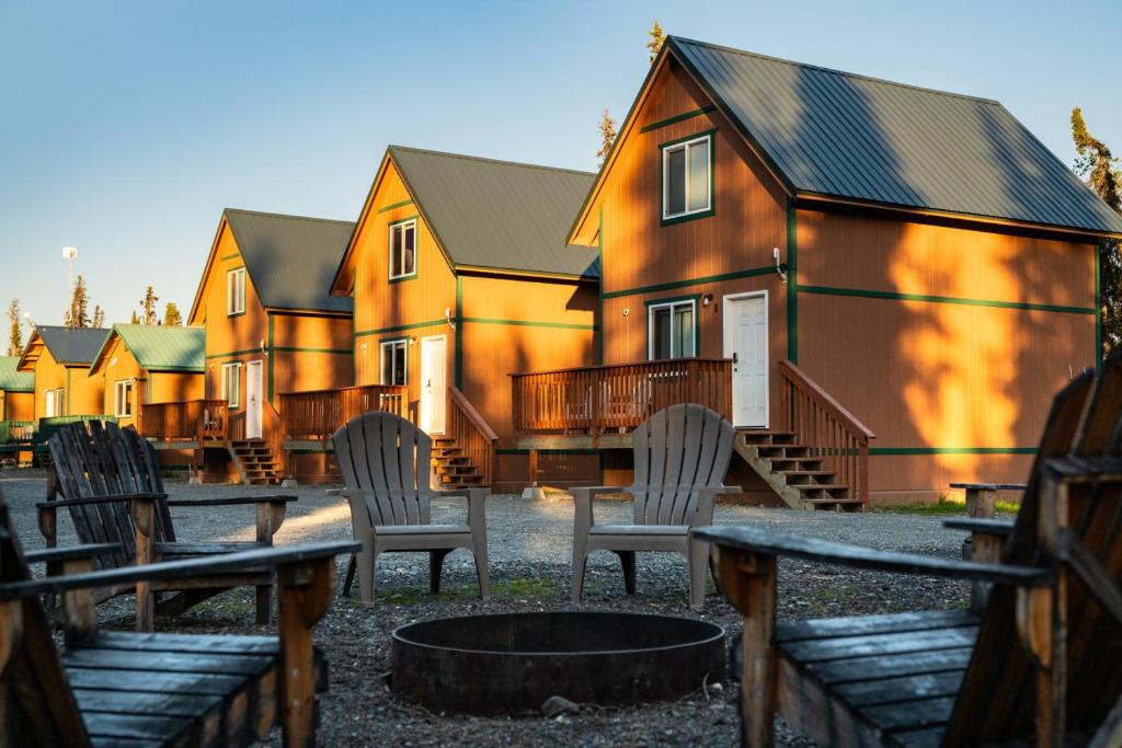 a group of chairs sitting in front of a building at Grayling Getaway, Cabin 1 at Lower Kenai Lodge in Kenai