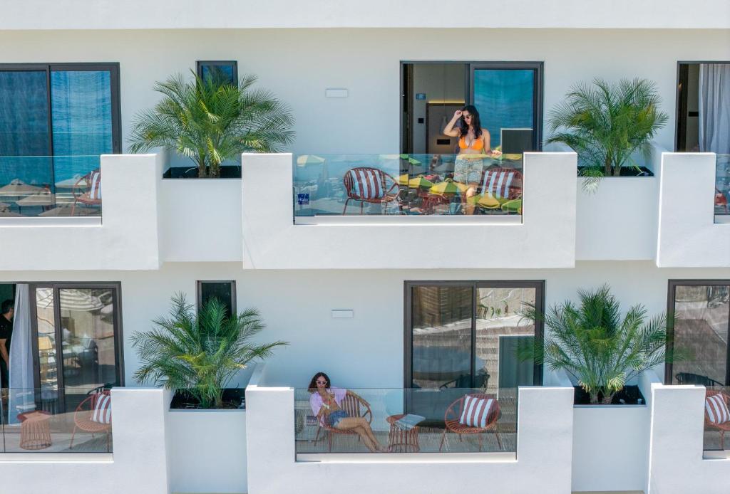 a woman sitting in a chair in a building at The Palms Kos in Kos