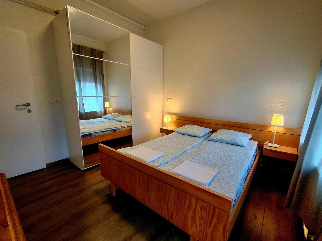 a bedroom with two beds and a mirror at KEF QuickStay Apartments in Keflavík
