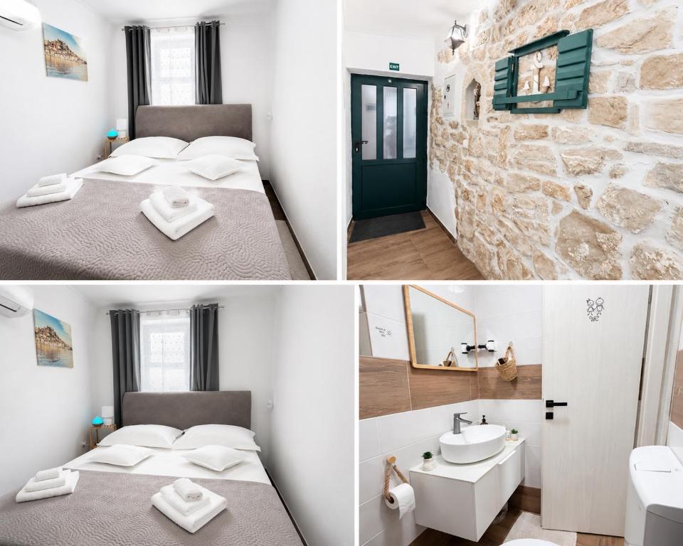 a room with two beds and a stone wall at Room Jakov in Šibenik
