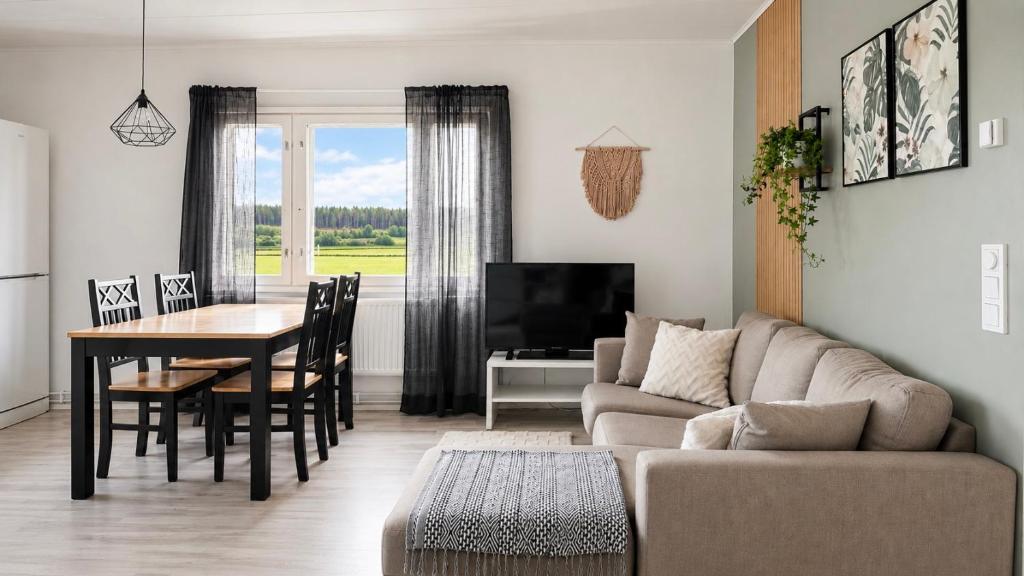 a living room with a couch and a table at Cozy apartment with sauna in Haapavesi