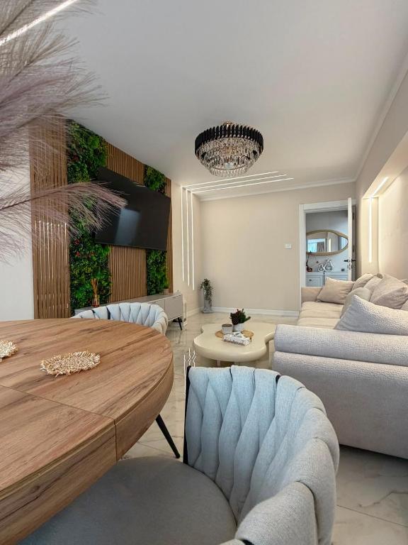 a living room with a table and a couch at Luma Apartment in Tecuci