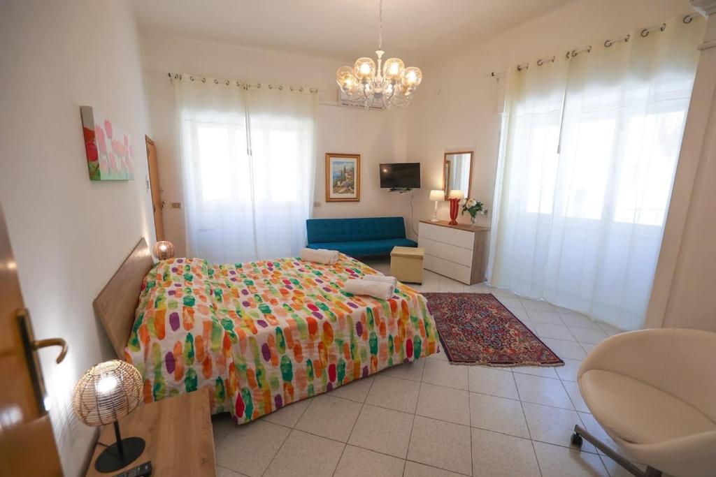 a bedroom with a bed and a couch in it at White Duomo Rooms in SantʼAgata di Militello