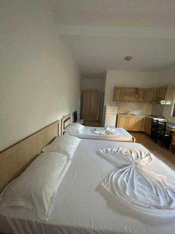 a large white bed in a room at Tale Breeze Apartments in Tale