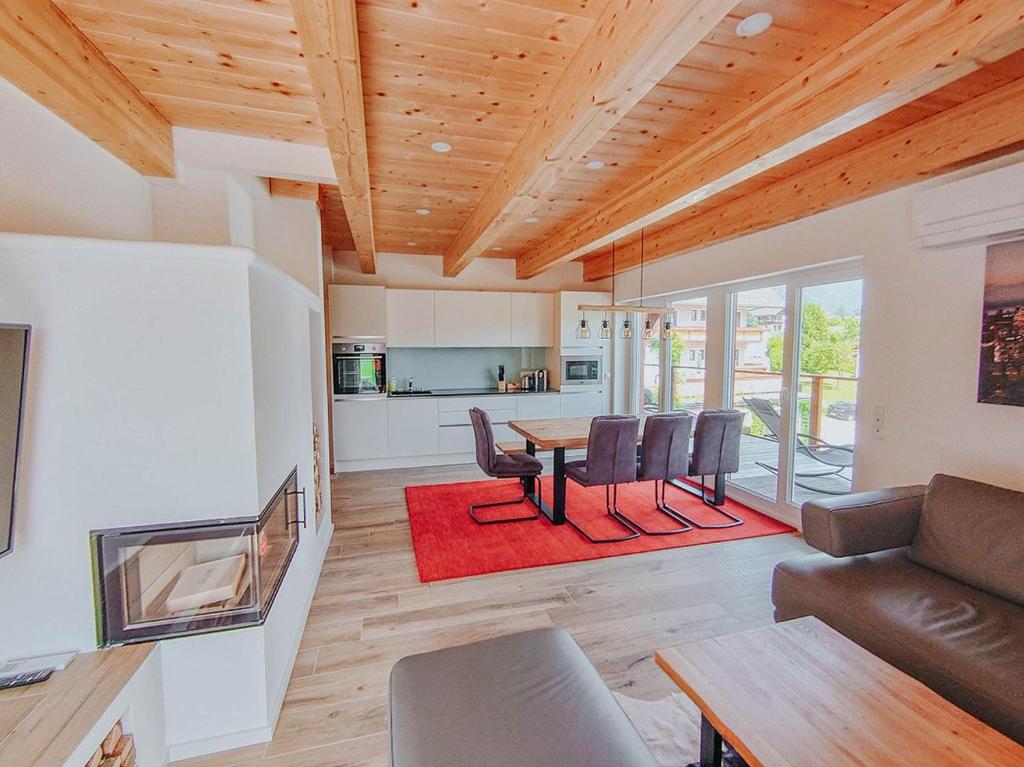 a living room with a table and chairs at Penthaus Aldebaran by Salzkammergood Living in Tauplitz