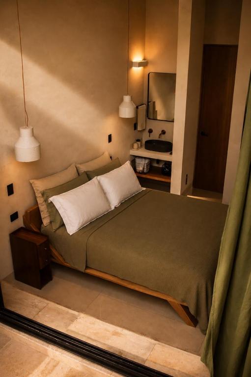 a bedroom with a bed and a mirror at Olivo Mio in La Paz