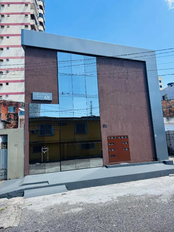 a building with a lot of glass windows at Loft Hage in Belém