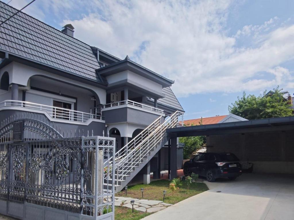 a house with a white staircase in a driveway at Panorama Residence Apartments in Kumanovo