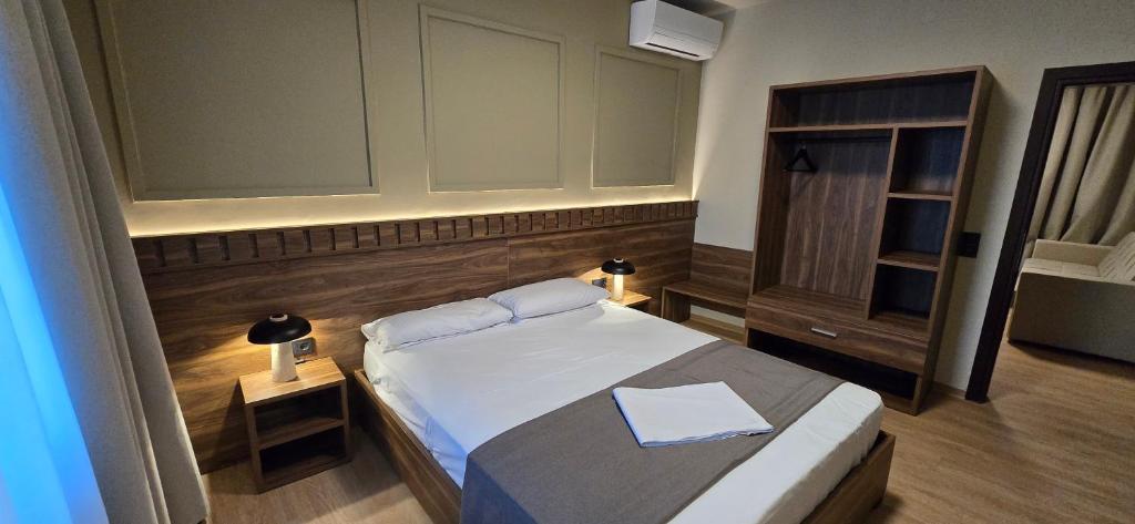 a small bedroom with a bed and a cabinet at Drei Schweizer Hotel in Neuwied
