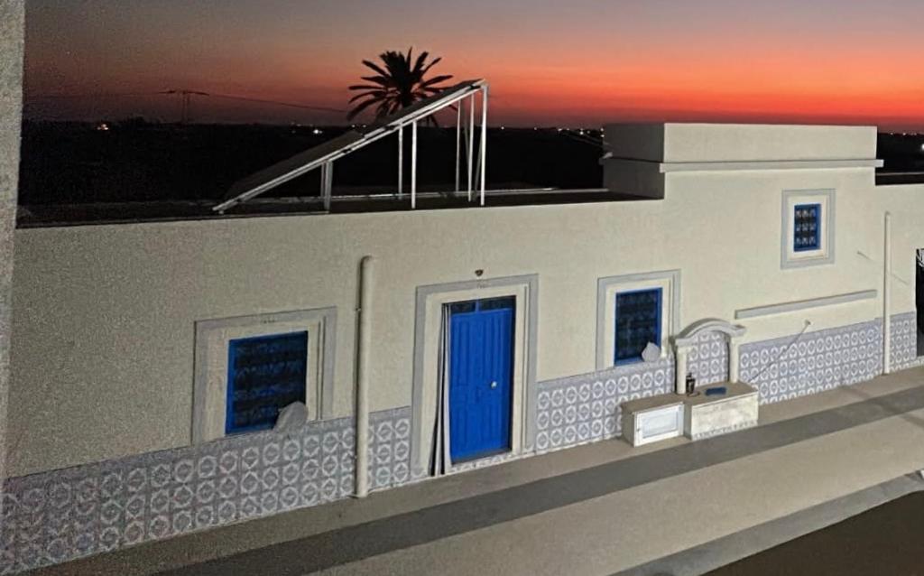 a model of a building with a blue door at Authentic, quiet and spacious house in El Guecheïne