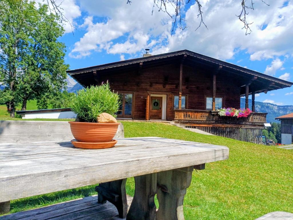 a wooden table in front of a house at Ferienwohnung Schösserhof in Reith bei Kitzbühel
