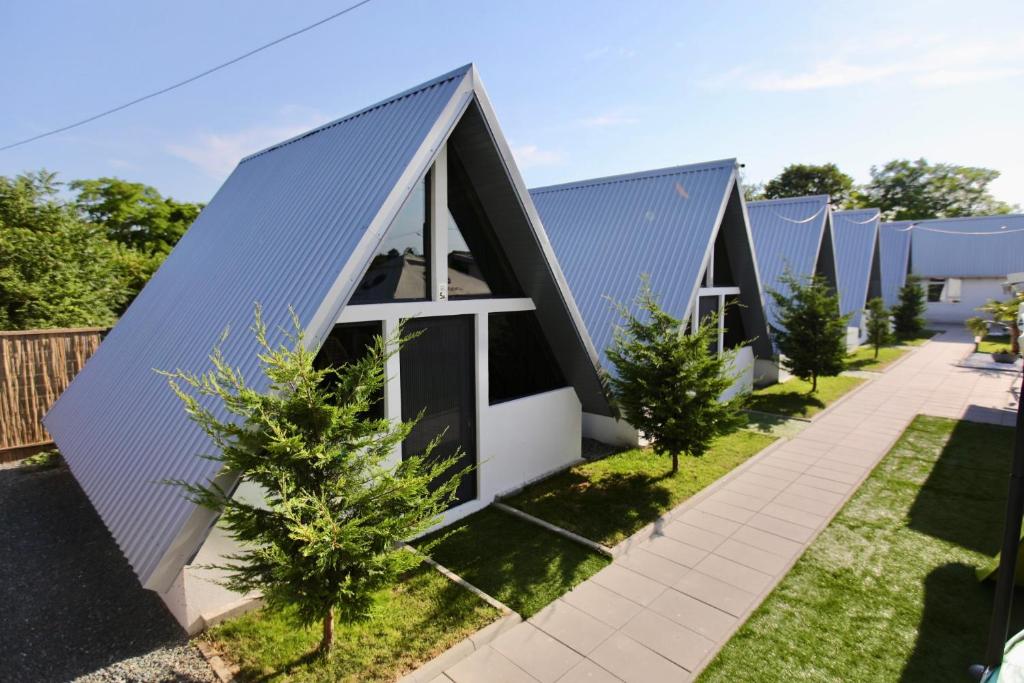 an image of a row of houses with trees at VLD House A Frame in Vadu