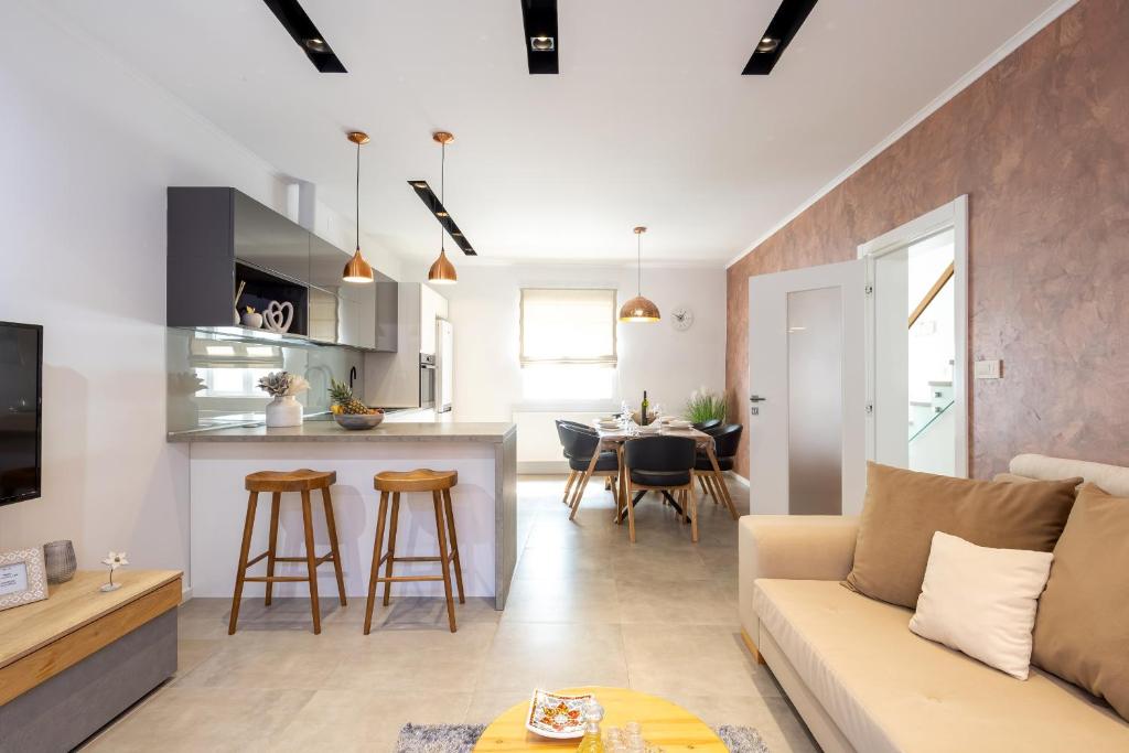 a living room and kitchen with a couch and a table at Island Breeze Oasis by Belmont Realty in Vela Luka