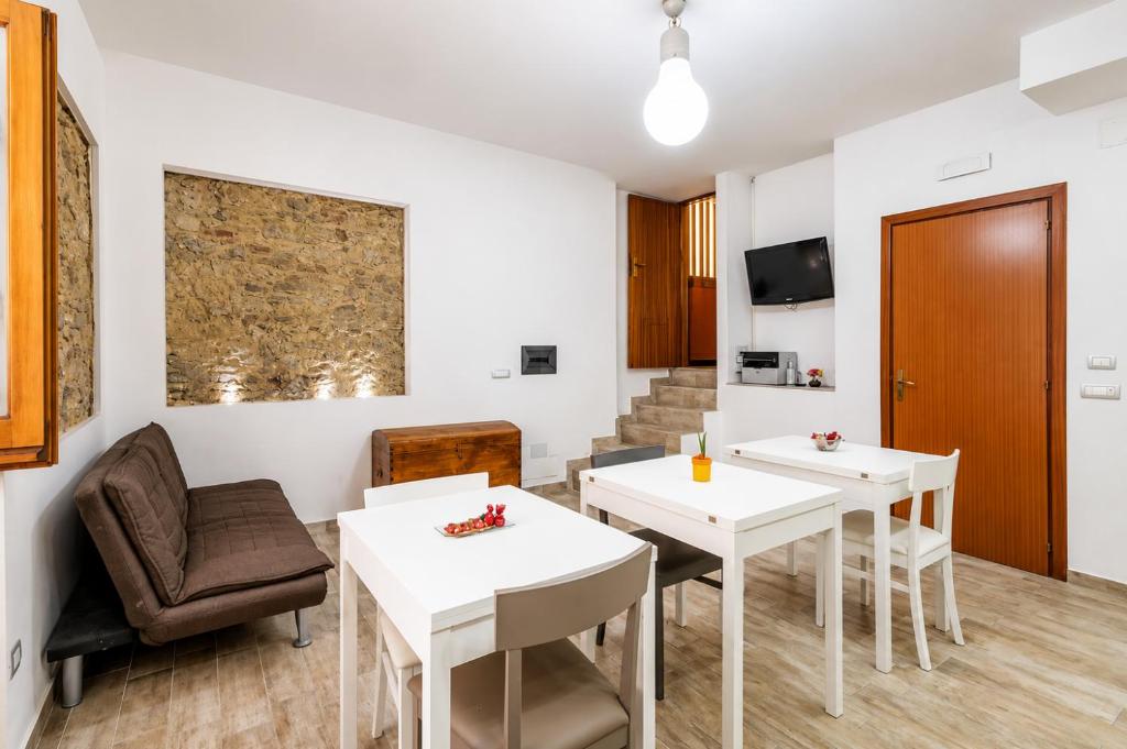 a room with two tables and a chair at Via Gagliardi - Centro in Vibo Valentia
