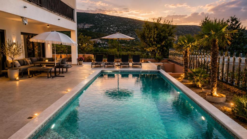 a swimming pool in the middle of a yard with a patio at Villa Cardellino in Klis