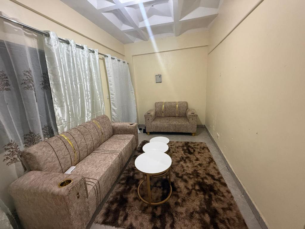 a living room with a couch and a table at Arabella Homes in Maralal