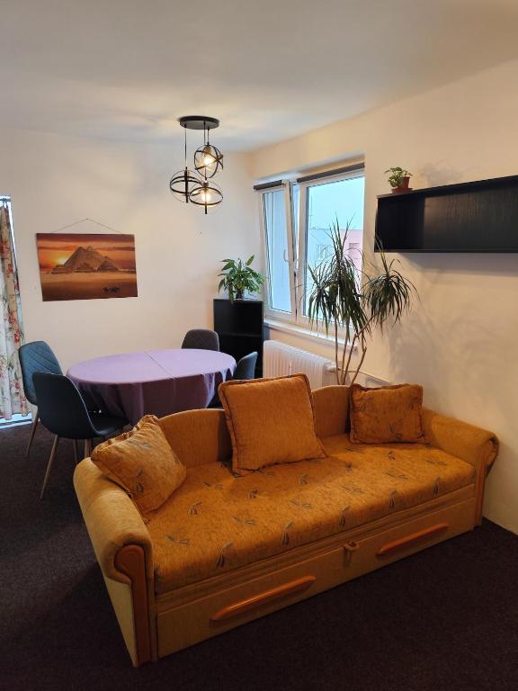 a living room with a couch and a table at Apartman Elizabeth in Pardubice