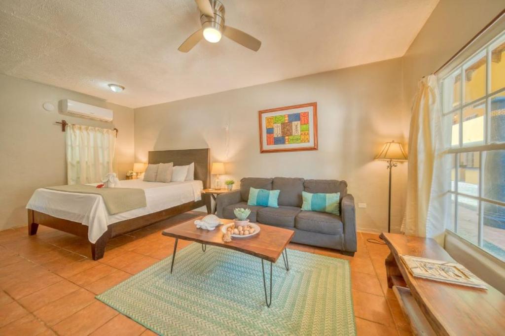 a living room with a bed and a couch at Caribe Tesoro in West Bay