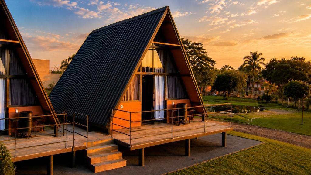 a house with a pitched roof on a deck at Chalés JH Serra da Canastra in São Roque de Minas