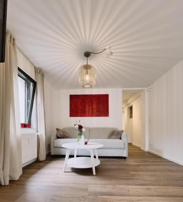 a living room with a white couch and a table at Cosy Place Xanten in Xanten
