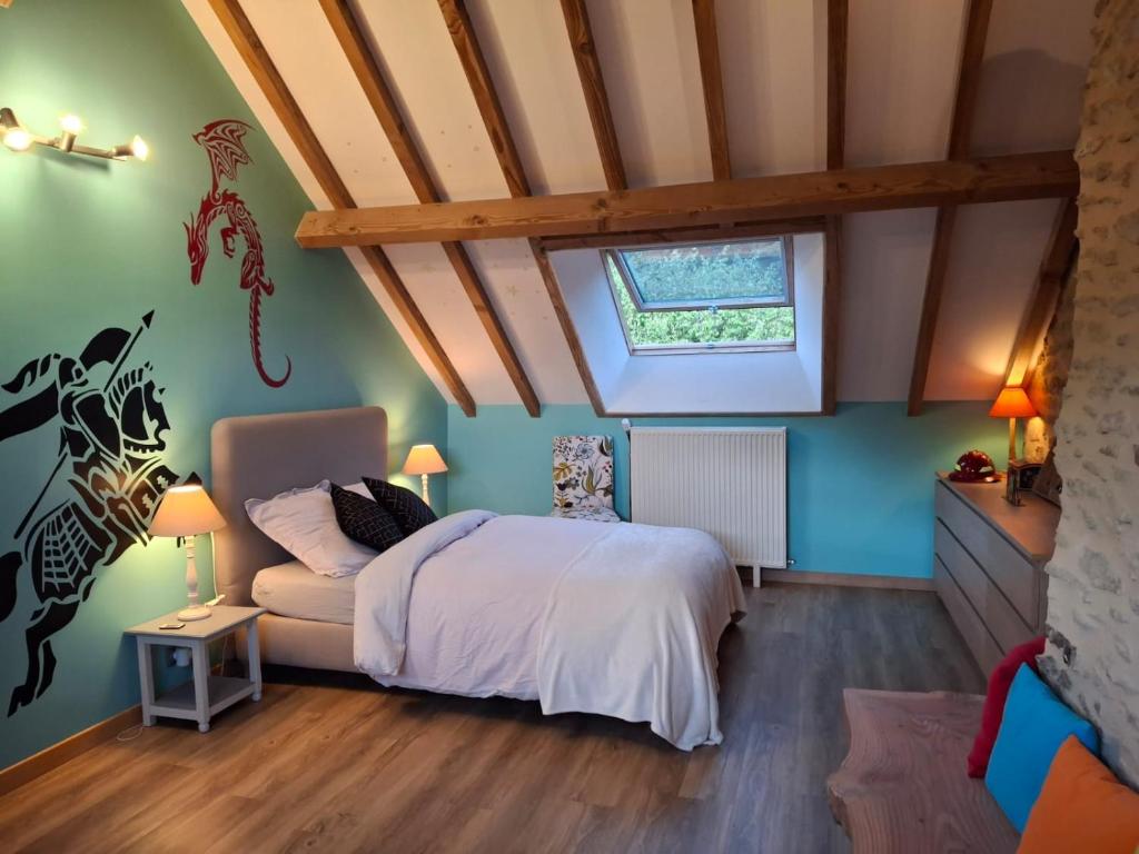 a bedroom with a bed and a window at Au Lou Pélélée in Madranges