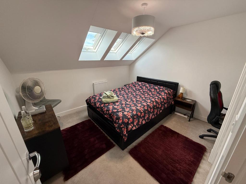 a small bedroom with a bed and a window at The Trinity - Double Room Suite 1 with Study and En-suite in High Wycombe